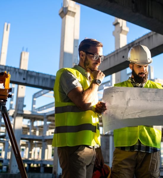 Architect and engineer construction workers working at outdoors construction site
